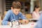 Close up of boy building robot at robotics school