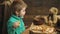 Close up of a boy eating a pizza on a wooden background. Little boy having a slice of pizza isolated on wooden