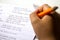 Close-up of boy hand with pencil writing English words. The boy writes his first test on English. Child writing