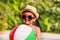 Close-up of boy in hat and sunglasses holding ball