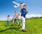 Close-up of boy holding airplane and kids behind