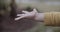 Close up of boy playing in the rain and getting his hands wet outside his home on a rainy and cloudy day