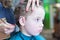 Close-up of boy sitting in barber chair