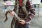 Close-up of boy volunteer showing a snake to a child and letting her touch the snake Holding a royal Ball python