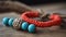 a close up of a bracelet with beads on a wooden surface with a piece of driftwood in the background and a piece of driftwood in