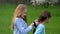 Close up braiding plait Young beautiful little girlfriend hairstyles outdoors