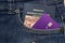 Close up of Brazilian passport, banknotes and credit card in pants pocket. Translate: Mercosur - Federative Republic of Brazil -