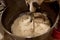 Close up bread dough preparation inside automatic dough kneading machine in bread factory. automated industrial baking concept