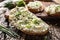 Close-up of bread slice with traditional Slovak bryndza spread made of sheep cheese with freshly cut chives placed on