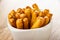 Close up of breadsticks with poppy in white bowl on wooden table