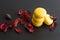 Close-up of breakfast morning with yellow macaroons lemon taste. close-up of french dessert on the black background and flowers