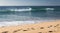 Close up on breaking wave coming to shore on sandy beach of atlantic coast, capbreton, france