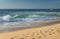 Close up on breaking wave coming to shore on sandy beach of atlantic coast, capbreton, france