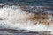 Close up of a breaking wave on the seashore.