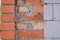 A close-up on bricklaying the wall with facing bricks over normal bricks and autoclaved aerated concrete blocks