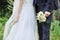 Close up of bride and groom hands. Wedding bouquet