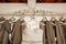 Close-up of the bride`s wedding dress against the background of the bridesmaid dresses on the cornice.