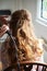 Close up on bride wedding hairdo with electric hair curler