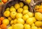 Close up of bright colored lemons and oranges in wooden buckets