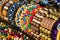 Close up of bright colorful wooden braided bracelets with beads at the street market, Moscow