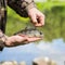 Close-up of Bright perch with a torn off hook on the line in palms fisherman. Concept fortune, finance, investment