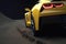 A close up of a bright yellow sports car accelerating around a tight bend on a rough dirt track. Speed drive concept. AI