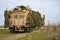 Close-up of a British army Mastiff protected patrol vehicle under green camouflage netting