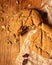 Close-up broken homemade fresh bread, pumpkin seeds and raisins on parchment paper wooden table