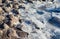 Close up on broken ice on a rocky shore