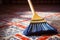 close-up of broom bristles sweeping a tiled floor