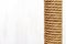 Close-up of brown cat scratching post on white background, copy space