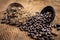 Close up of brown colored dried custard apples or sitaphal or sugar apple seeds in a black colored clay bowl and its powder of gro