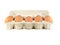 Close up of brown eggs in a egg tray. Chicken eggs. Fresh eggs on a white background