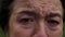 Close-up brown eyes of depressed senior woman crying looking at camera. Portrait of hopeless frustrated Caucasian