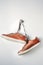 Close up of brown leather men`s shoes hang on nail on white background