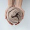 Close-up of brown merino wool ball in hands