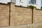 A close-up on brown oyster shell foamed brick, limestone brick fence with support pillars