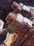 close up of brown rusted threaded bolts and nuts on old corroded machinery