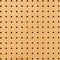 Close up of brown yellow wall surface holed grid texture. dot pattern