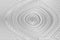 Close up of brushed spiral shape white wall texture for background. Wood texture of cutted tree trunk. In shades of gray. 3D