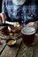 Close-up brutal gray-haired adult man with a beard eats mustard steak and drinks beer, concept of a holiday, festival, Oktoberfest