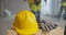 Close up of builder putting safety hardhat and gloves on wooden box