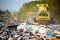 Close up of a bulldozer on the huge household landfill or dump waste, environmental or ecology problem