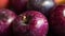 a close up of a bunch of apples with water droplets on them and a yellow apple in the background with a red apple in the middle