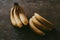 Close-up of a bunch of bananas on a brown background
