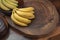 Close up bunch of bananas with wooden trunk background, normal appearance