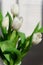 Close-up of a bunch bouquet of beautiful white tulips indoors.