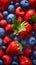 A close up of a bunch of strawberries and blueberries