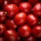 a close up of a bunch of tomatoes with water droplets on them