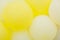 Close up of bunches and groups of yellow helium balloons